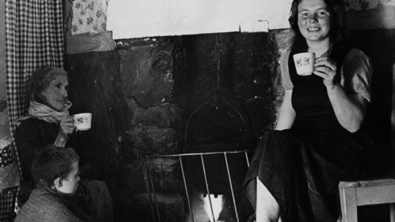 A family drinking tea by the hearth in Donegal, 1945. Photograph: Ron Bell/Fox Photos/Getty Images