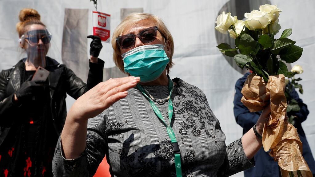 Malgorzata Gersdorf holds a flower bouquet as she speaks to her supporters during her last day as supreme court president in Warsaw this week. Photograph: Kacper Pempel/Reuters