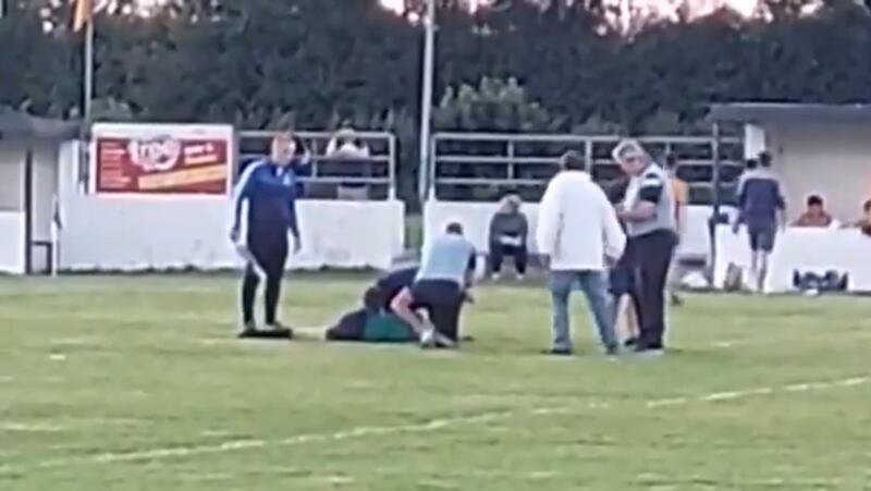 Referee Kevin Naughton lies injured following an incident during a minor football game in Roscommon