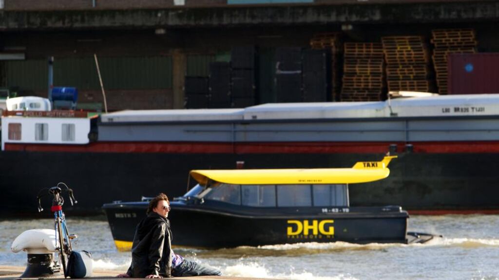A man sits in the harbour of Rotterdam, where armed detectives in Rotterdam seized their biggest haul of cocaine in a decade at the weekend. AFP PHOTO/ANP/ROBIN UTRECHT
