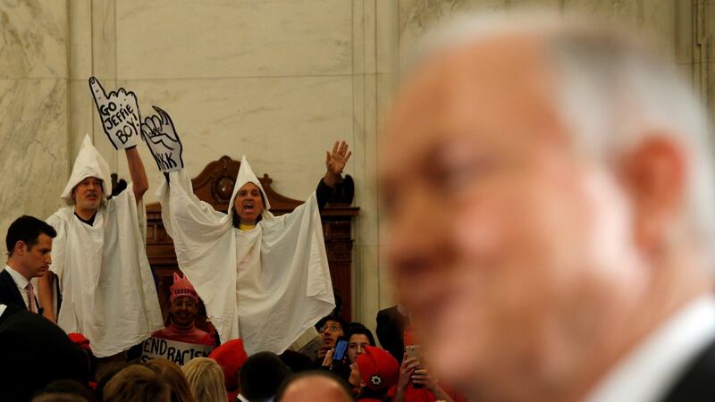Protesters dressed as Ku Klux Klan members disrupt the start of a Senate Judiciary Committee confirmation hearing for US attorney general-nominee Senator Jeff Sessions on Capitol Hill in Washington. Photograph: Kevin Lamarque/Reuters