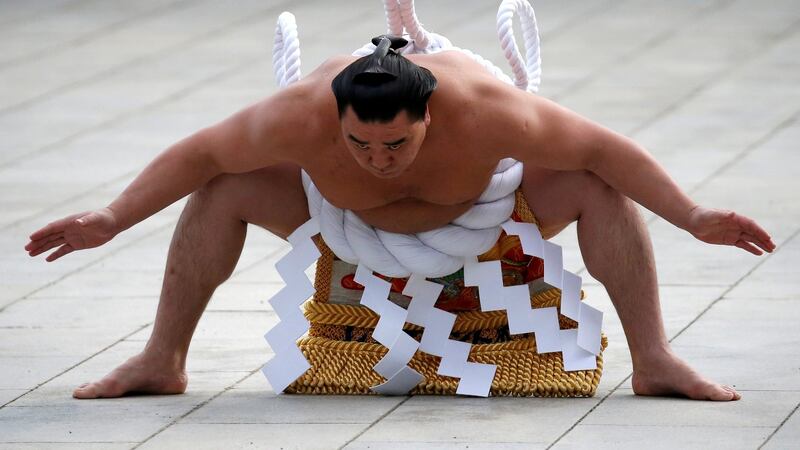 Mongolian-born grand sumo champion Yokozuna Harumafuji performs the New Year’s ring-entering rite at the annual celebration for the New Year at Meiji Shrine in Tokyo. Photograph: Issei Kato/Reuters