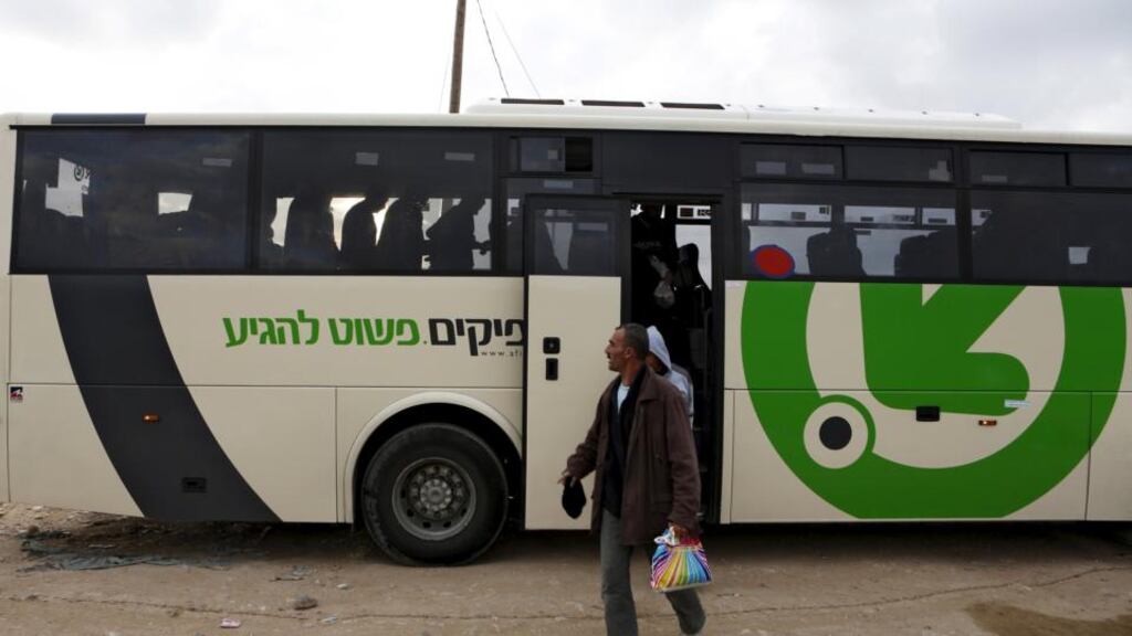 Labourers disembark a Palestinians-only bus before crossing to the West Bank through Israel’s Eyal checkpoint. Israel’s prime minister Binyamin Netanyahu has cancelled  a plan to segregate Palestinians from Israelis on West Bank buses. Photograph: Baz Ratner/Reuters