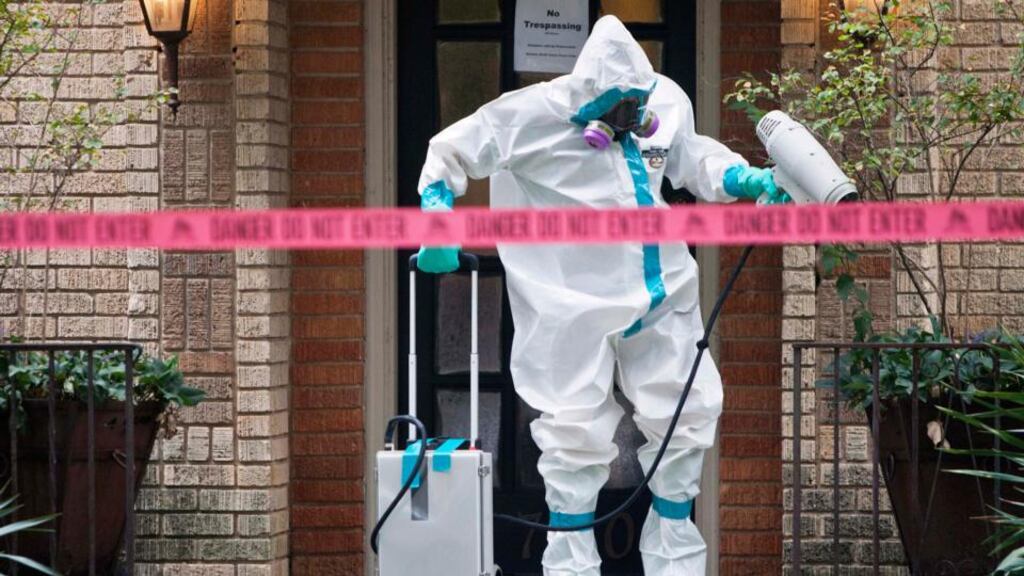 A member of the Environmental HazMat team disinfects the entrance to the residence of a health worker at the Texas Health Presbyterian Hospital who has contracted Ebola in Dallas, Texas. Photograph: Jaime R Carrero/Reuters