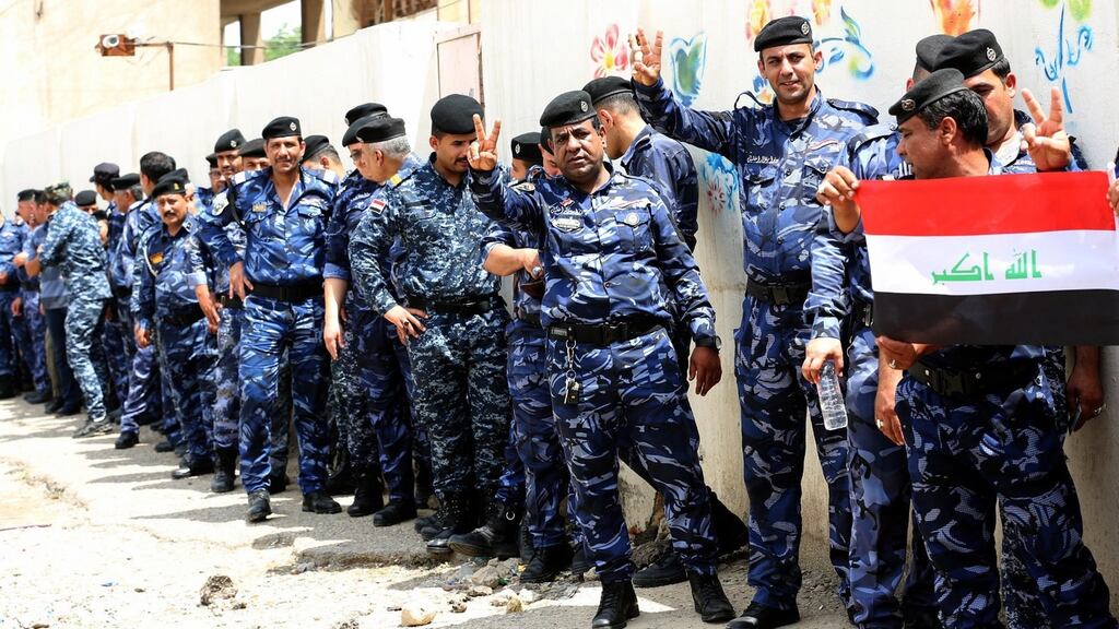 Men stand in line to cast their votes during a special voting day for members of the security forces on Thursday, ahead of Iraq’s parliamentaryh elections this weekend. Photograph: Ali Abbas/EPA