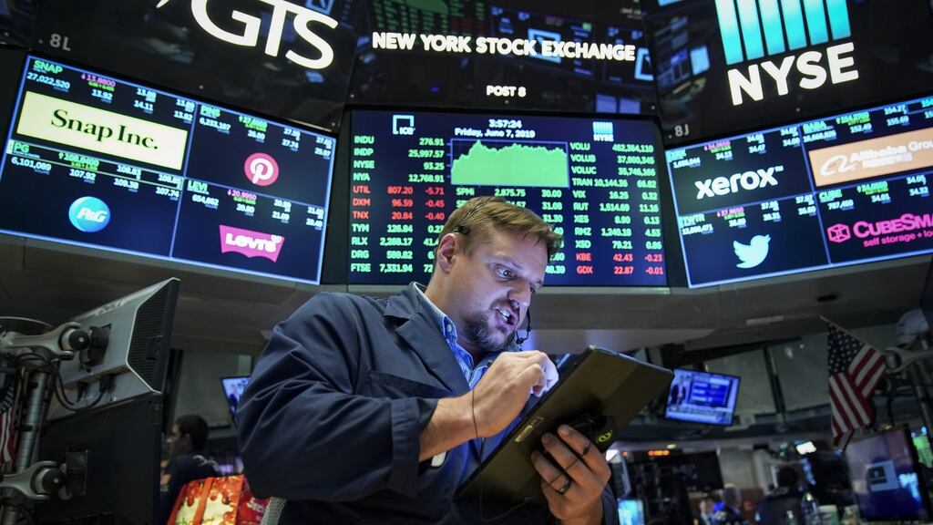 A trader works on the floor of the New York Stock Exchang at the closing bell.