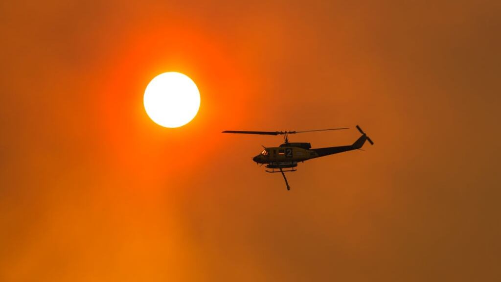 Water bombing helicopters have been regularly deployed in recent weeks in an attempt to put out bushfires in Tasmania. Photograph: Heath Holden/Getty Images