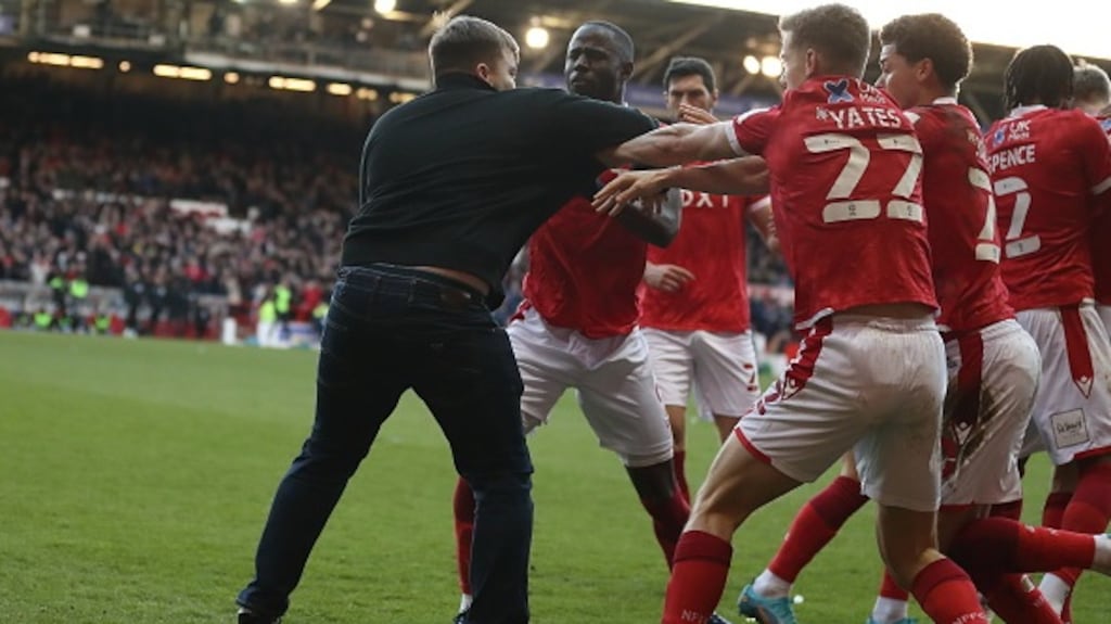 A pitch invader attacks players of Nottingham Forest during the Emirates FA Cup Fourth Round match between Nottingham Forest and Leicester City. Photograph: James Williamson/AMA/Getty Images