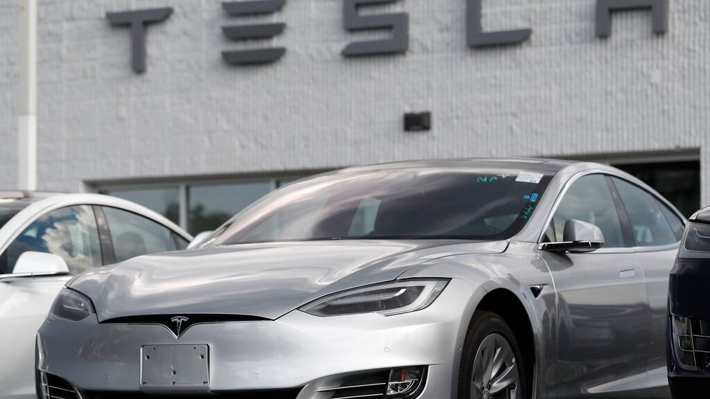 A Tesla 2018 Model 3 sedan on display outside a showroom in the US. Tesla is recalling nearly 12,000 US vehicles sold since 2017 because a communication error may cause a false forward-collision warning or unexpected activation of the emergency brakes. Photograph: AP Photo/David Zalubowsi, File