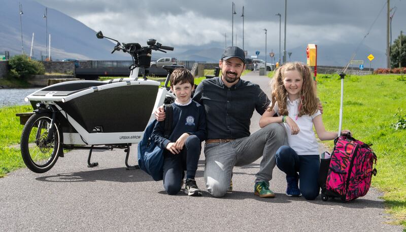 Anluan Dunne from Co Kerry collects his children Arthur (8) and Iseut (11) from school Photograph: Domnick Walsh/Eye Focus