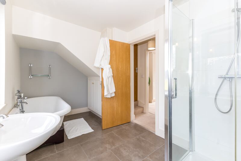 The main bathroom has a free standing bath