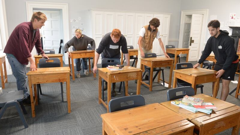 Former students (from left) Jake Rowan Hamilton, Marta Mora Ortega, Michael Blakiston Houston, Finn Doyne and Sholto O’Brien preparing one of the class rooms at Headfort School as it prepares to reopen in September.Photograph: Dara Mac Dónaill / The Irish Times