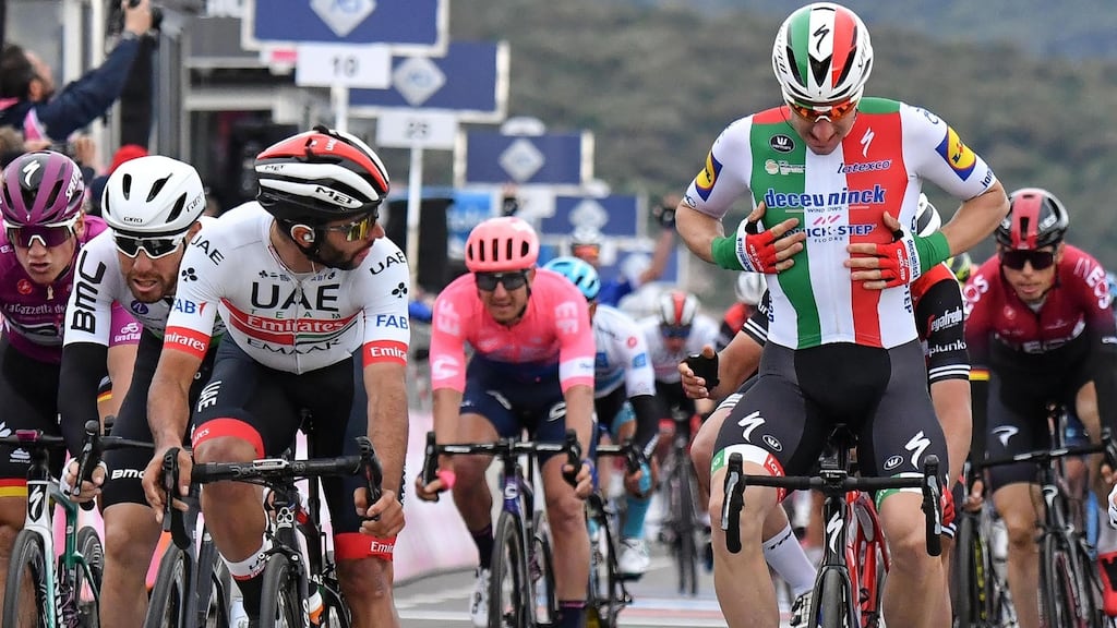 Colombian rider Fernando Gaviria of the Uae Team Emirates and Italian rider Elia Viviani of the Deceuninck-Quick Step team react after crossing the finish line of the third stage of the Giro d’Italia. Photograph: EPA