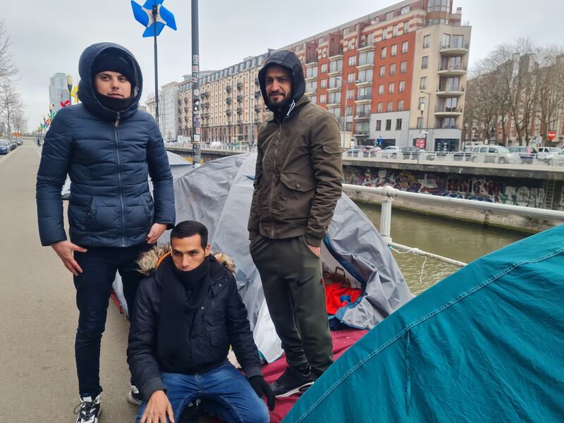 Palestinian and Syrian men outside the tent they share in Brussels. Photograph: Naomi O'Leary