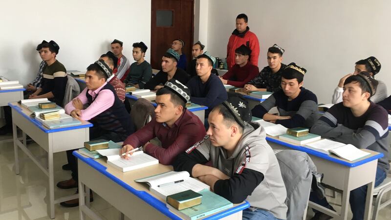 Islamic studies students attend a class at the Xinjiang Islamic Institute during a government organised trip in Urumqi, Xinjiang, China. Photograph: Ben Blanchard/Reuters