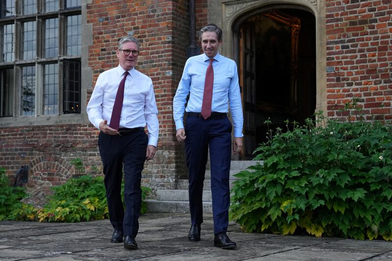 Keir Starmer and Simon Harris walk through the garden during a meeting at Chequers on Wednesday. Photograph: Carl Court/Pool/AFP via Getty Images