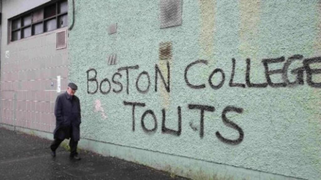 A man walks past graffiti on a wall off the Falls Road, Belfast, in 2014. photograph: Paul Hackett/Reuters