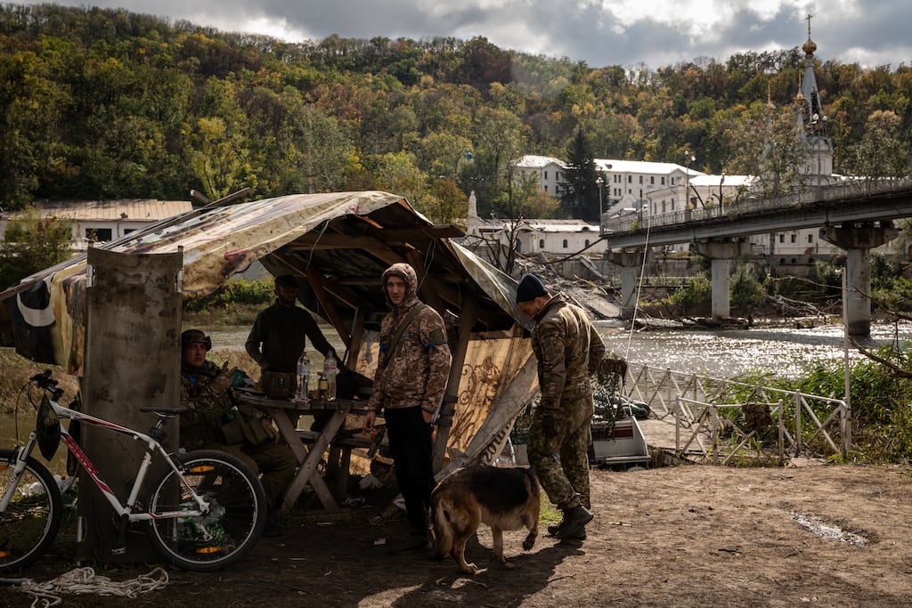 Ukraine soldiers at the Siverskyi Donets river across from the war-damaged Monastery of the Caves in Sviatohirsk, eastern Ukraine. Photograph: Nicole Tung/The New York Times