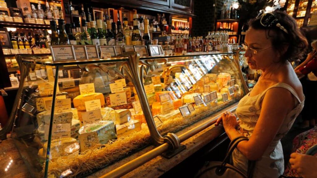 A woman looks at a variety of cheeses in a supermarket in St Petersburg. The Russian government announced a ban on food imports from the EU, US, Norway, Canada and Australia. Photograph: EPA/Anatoly Maltsev