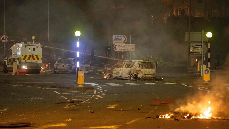 Damaged cars and open flames in Newtownabbey, Belfast. Photograph: Paul Faith/AFP via Getty