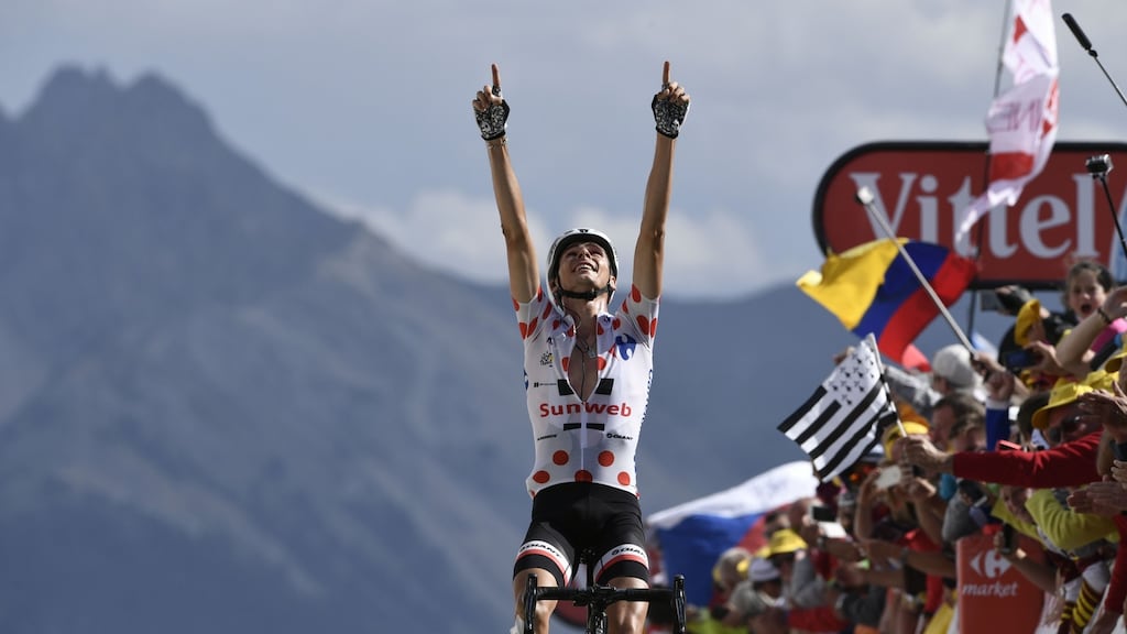 France’s Warren Barguil, wearing the best climber’s polka dot jersey, celebrates as he crosses the finish line at the end of the 18th stage. Photograph: Getty Images