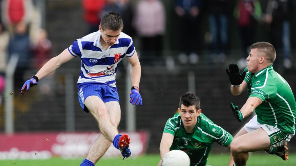 Ruairi O Cioleain of O’Mahony’s shoots to score his side’s first goal despite a block attempt from Conor Carton of Donaghmore-Ashbourne. Photograph: Tommy Grealy / Inpho