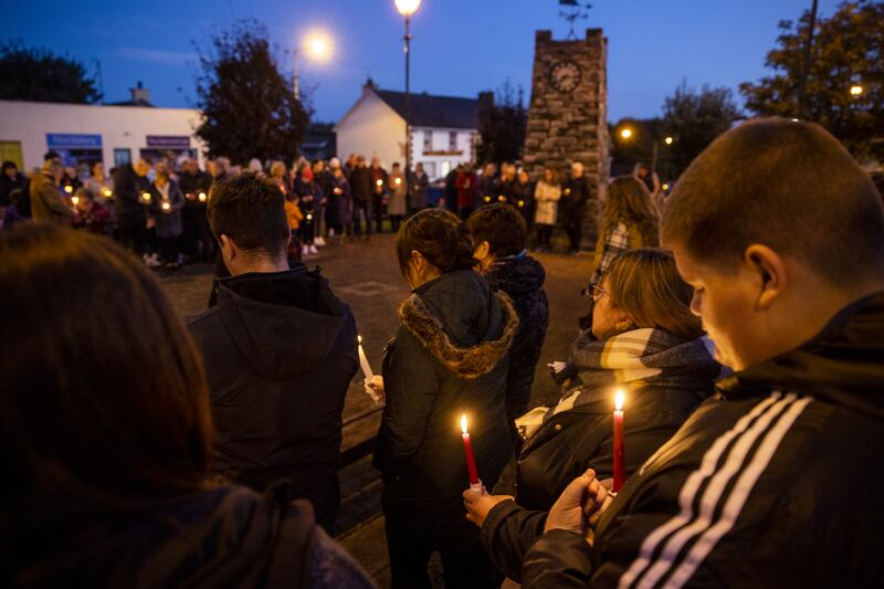 Mourners hold candles during a moment silence in Castlefinn, Co Donegal, at a vigil for the victims of the explosion. Photograph: Liam McBurney/PA
