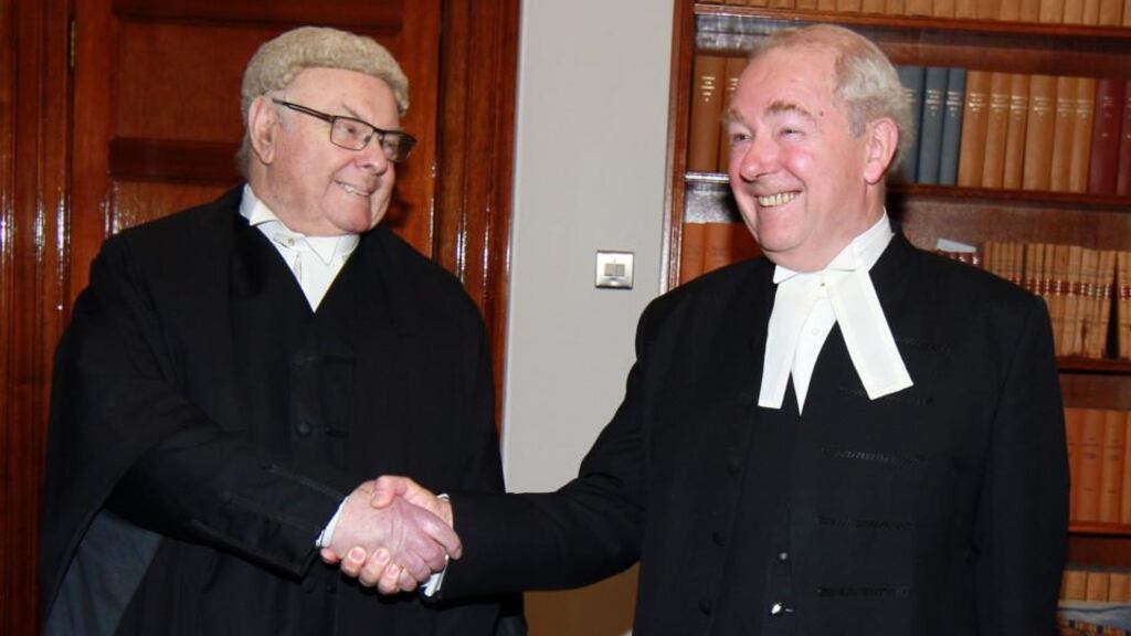 Mr Justice Paul Carney receives a congratulatory handshake from the president of the High Court, Mr Justice Nicholas Kearns, at the Four Courts on the occasion of his retirement. Photograph: Collins Courts