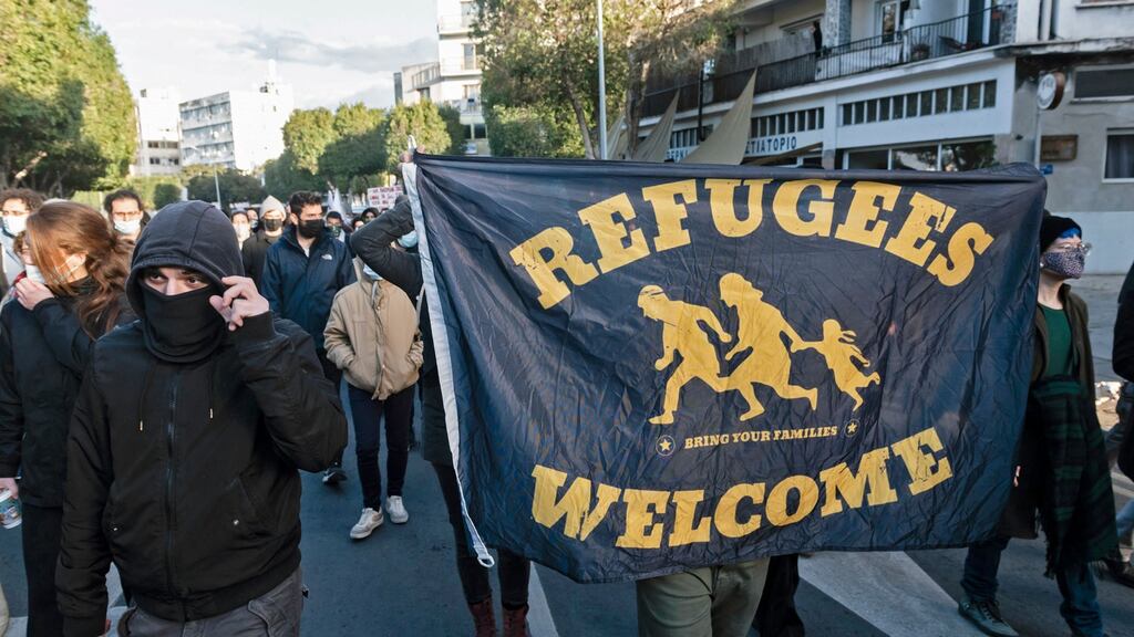 Demonstrators carry a banner for refugees as they march against corruption in the Cypriot capital Nicosia. Photograph: Lakovos Hatzistavrou/AFP via Getty Images
