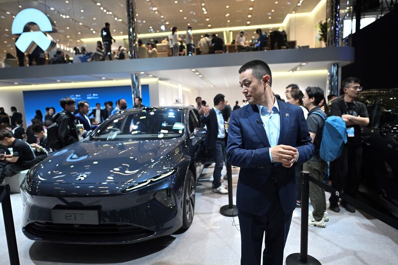 William Li, CEO of Nio stands next to the firm's ET7. Photograph: Pedro Pardo/AFP via Getty Images