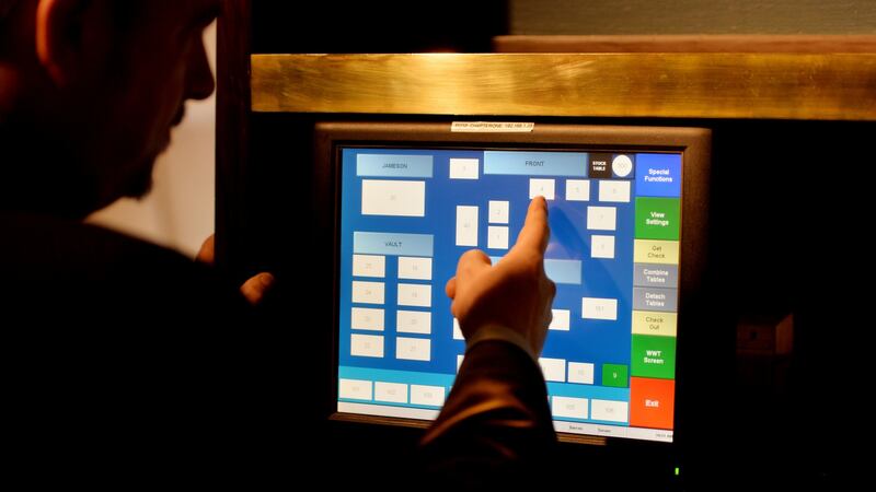 Darren Campbell, restaurant manager, working the order management system