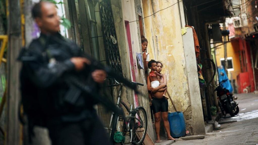 A military police officer patrols Complexo da Maré, one of the largest favelas in Rio. Photograph: Mario Tama/Getty Images