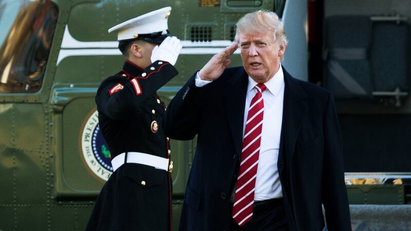 President Donald Trump salutes a Marines honor guard as he disembarks from Marine One upon arrival at the White House in Washington on Monday. Photograph: AP
