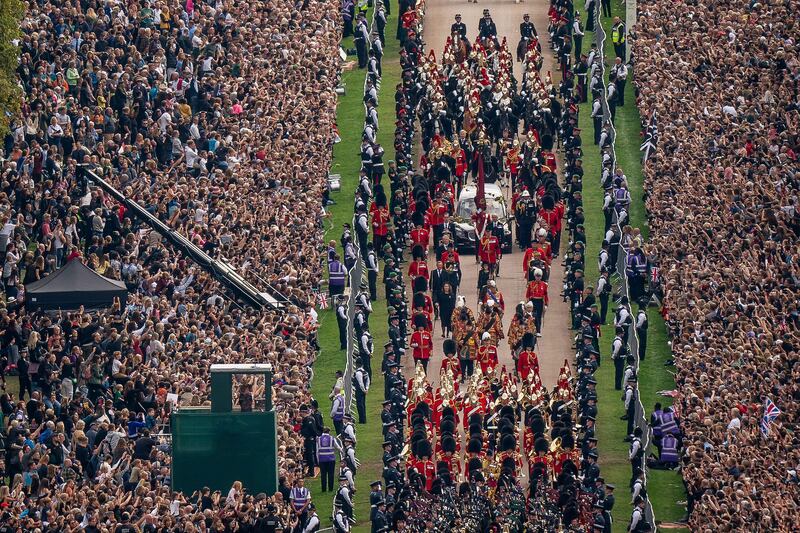 The ceremonial procession following the coffin of Queen Elizabeth II travels up The Long Walk in Windsor. Photograph: Aaron Chown/Pool/AFP
