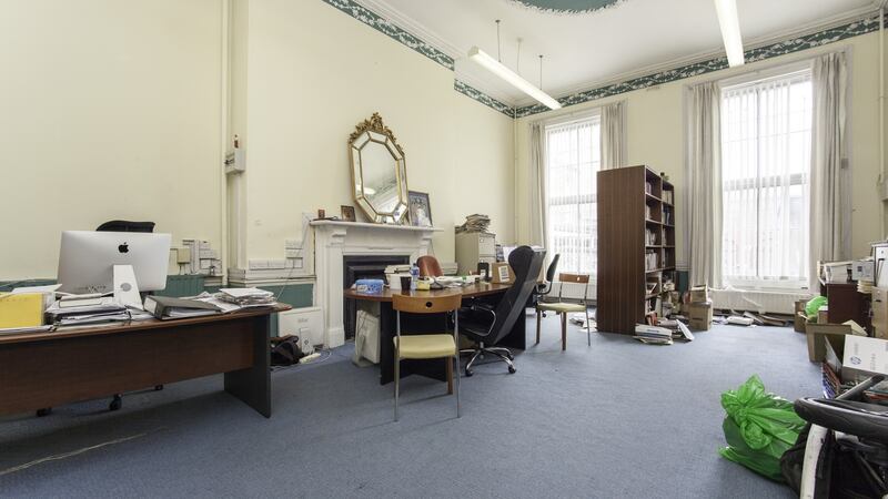 There are two rooms at hall level. The room to the rear has a beautiful oval ceiling plaster.