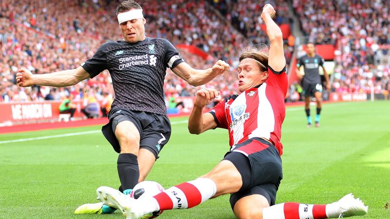 Liverpool’s James Milner and Jannik Vestergaard of Southampton compete for the ball   at St Mary’s Stadium   in Southampton. Photograph: Warren Little/Getty Images