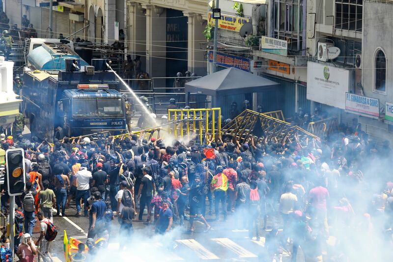 Police use water canon and tear gas to disperse the protesters in Colombo. Photograph: Amitha Thennakoon/AP