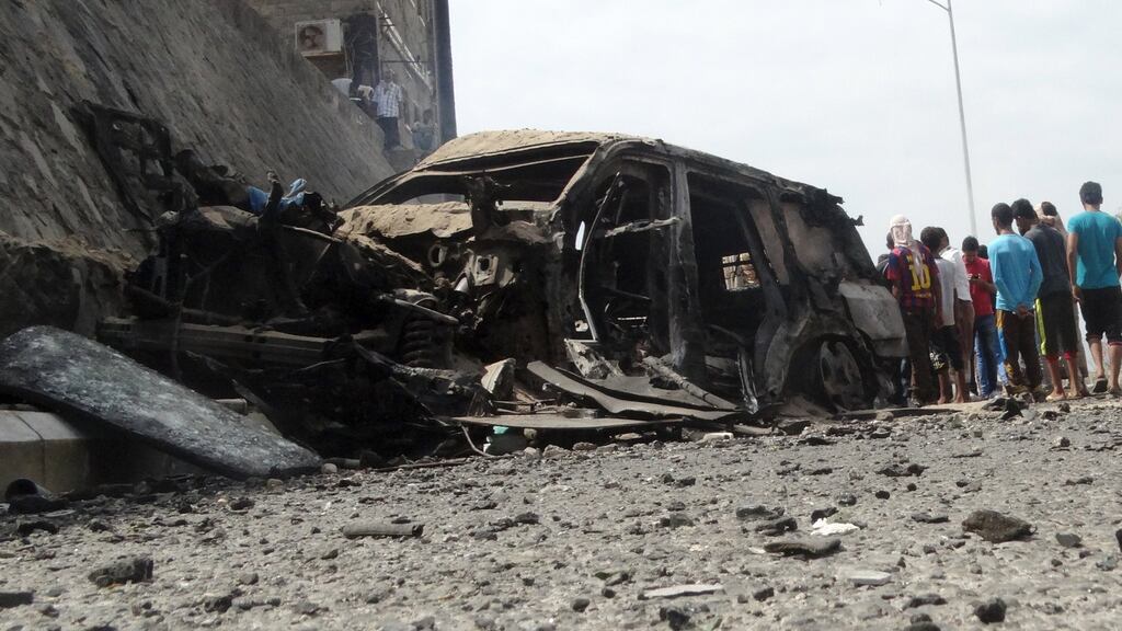 Islamic State claimed responsibility for an explosion which killed the governor of Yemen’s southern Aden province on Sunday. Above, people gather at the site of the car bomb attack. Photograph: Nasser Awad/Reuters.