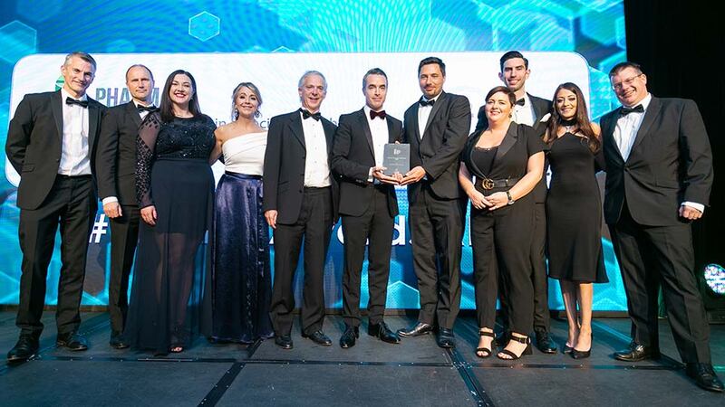 Adam O’Sullivan, Director of Pharmaceutical & Healthcare, Kuehne + Nagel Ireland presents the Pharma Company of the Year - SME award to the Ipsen Manufacturing Ireland team.
