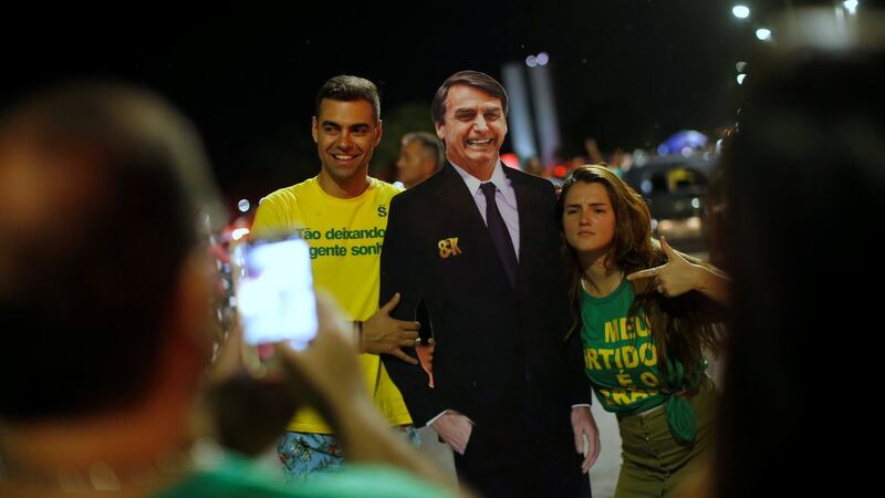 Supporters of Jair Bolsonaro react after he wins the presidential race, in Brasilia. Photograph: Reuters/Adriano Machado