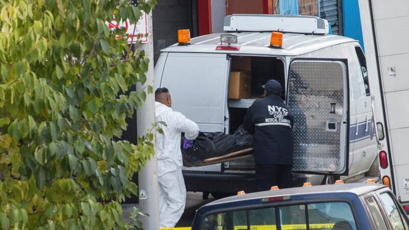 Bodies are removed by the police from the scene of a triple murder in the Brooklyn borough of New York. A rock musician fatally shot three members of the Yellow Dogs, a rock band of Iranian expatriates, before taking his own life, the police said. Photograph: Uli Seit/The New York Times.