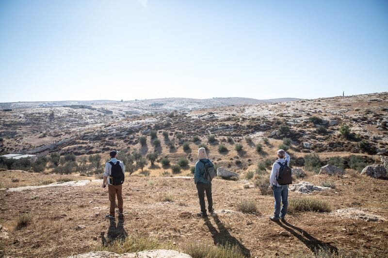 Israeli and international activists scan for settlers or Israeli security forces in the South Hebron Hills. Photograph: Sally Hayden