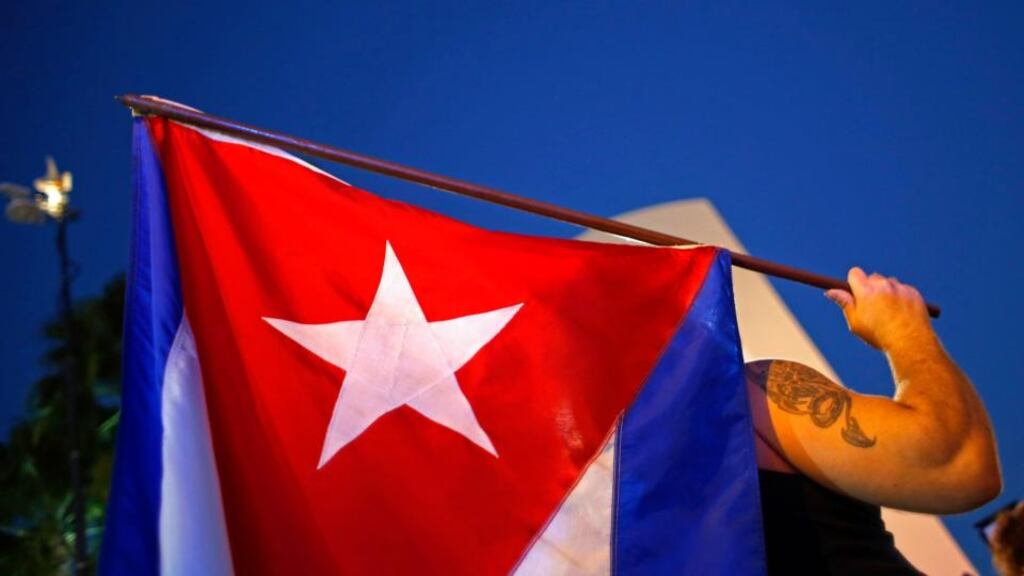 An anti-Castro Cuban exile in Florida holds a Cuban flag during a protest after the announcement of the restoration of diplomatic ties between Cuba and United States. Photograph: Carlos Barria/Reuters