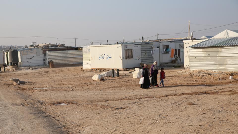 Women walk through Zaatari refugee camp in Jordan, currently home to 80,000 Syrian refugees. Photograph: Sally Hayden