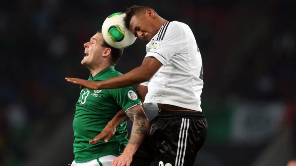The Republic of Ireland’s Anthony Stokes and Jerome Boateng of Germany contest an aerial ball during the World Cup qualifier in Cologne. Photograph: Donall Farmer/Inpho