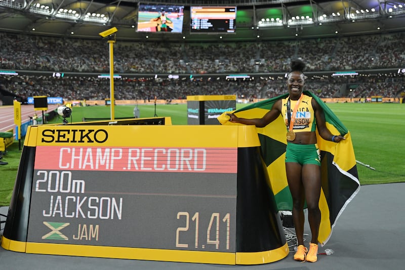 Shericka Jackson celebrates winning the Women's 200m Final next to her championship record. Photograph: David Ramos/Getty