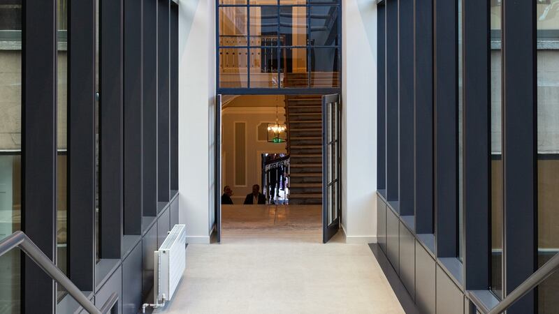 An interconnecting glass corridor links the original property to a new seven-storey office building to the rear