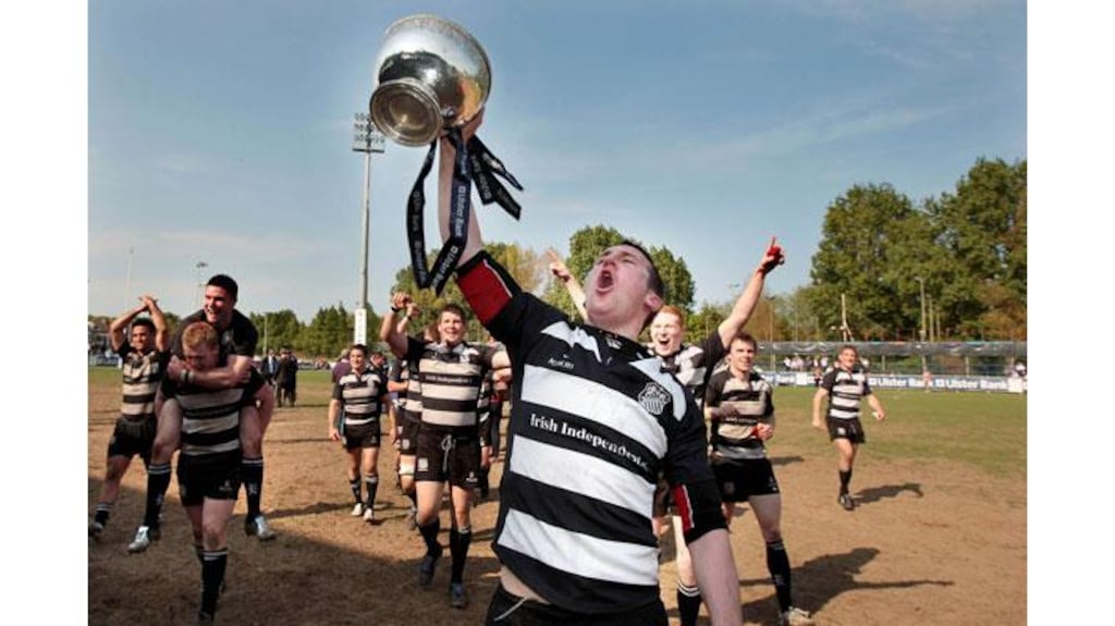 Old Belvedere's Conal Keane celebrates with the Ulster Bank League Division 1 trophy after their win over Cork Constitution at Donnybrook. Photograph: Morgan Treacy/Inpho