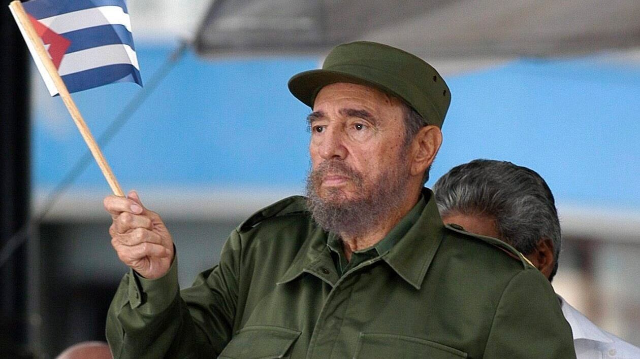 A file picture from 2005 shows Cuban president Fidel Castro waving the national flag after giving a speech in Havana. Photograph: EPA