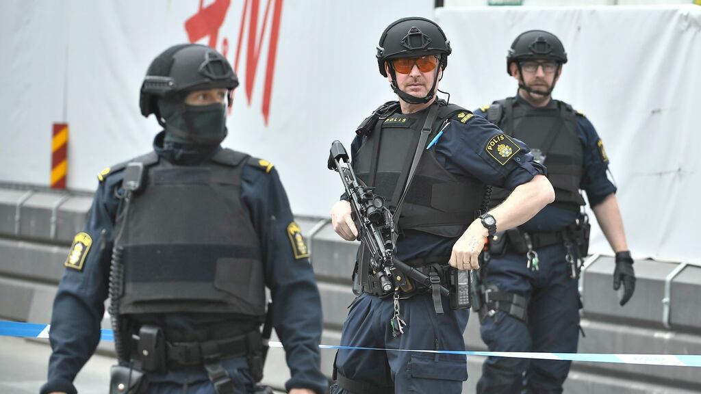 Swedish police officers near the scene where a truck crashed into a department store in central Stockholm. Photograph: EPA